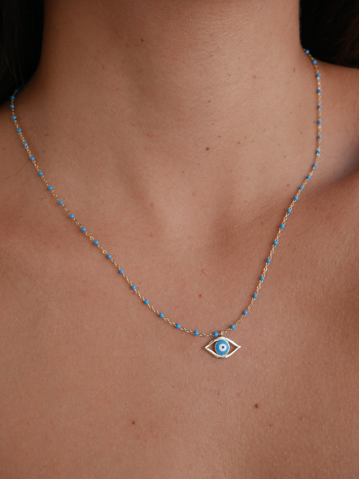 evil eye necklace baby blue or sky blue evil eye necklaces unique dainty lucky necklaces for protection  designer inspired eye necklaces trending and popular designer inspired 14k gold plated .925 sterling silver unique trending festival jewelry waterproof gift ideas for men and woman shopping in Miami, Brickell jewelry store Kesley Boutique